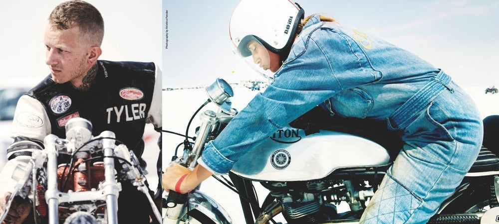 Motorcyclist near a motorcycle, with another person standing beside the bike